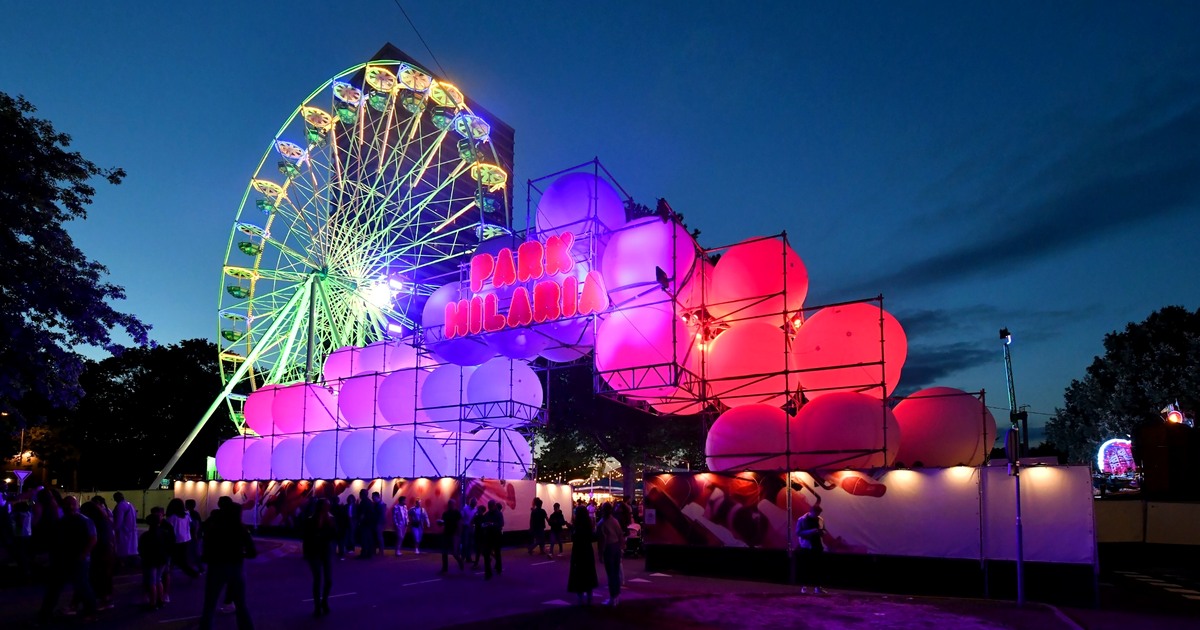 Colourfully illuminated Park Hilaria and Ferris wheel at night